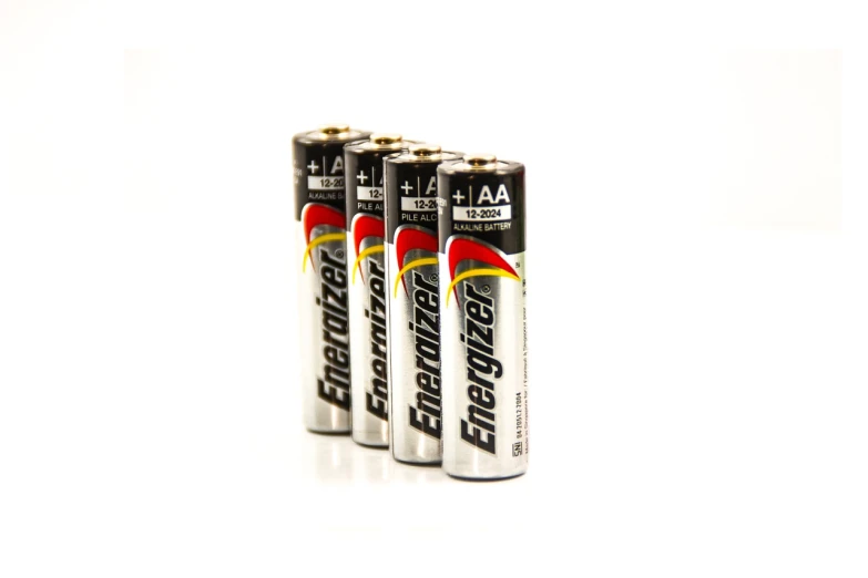 a group of four batteries sitting on top of each other, productphoto, emperor, ultra realistic ”, new zealand
