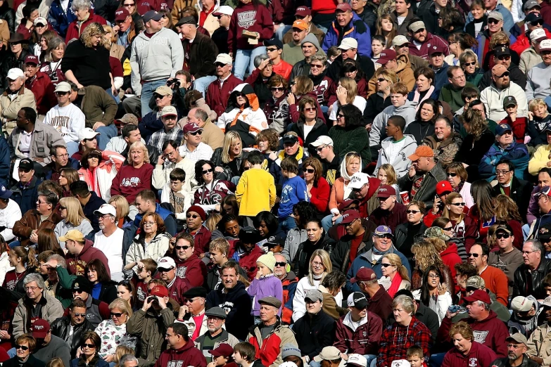 a large group of people standing next to each other, by Tom Carapic, flickr, interrupting the big game, maroon and white, colorful crowd, slightly sunny weather