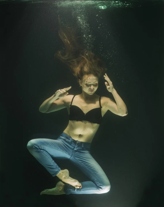 a woman in a bikini swims under water, a portrait, renaissance, shot at dark with studio lights, clothes floating, terrified, hair is floating