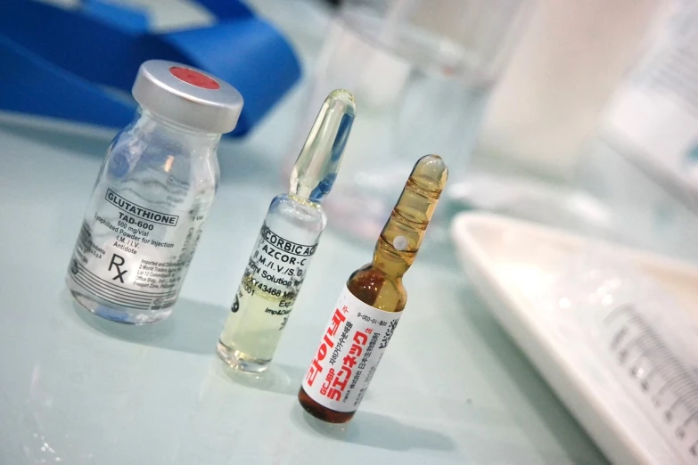 a couple of vials sitting on top of a table, a picture, photograph credit: ap, steroids, ((sharp focus)), syringe