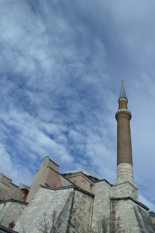 a tall tower with a clock on top of it, by Jan Rustem, hurufiyya, ottoman sultanate, with clouds in the sky, brick, lead - covered spire