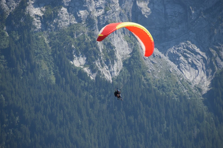 a person that is in the air with a parachute, a picture, figuration libre, lauterbrunnen valley, 7 0 mm photo