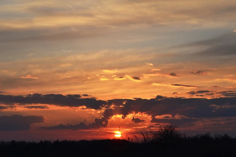 the sun is setting behind the clouds in the sky, a picture, flickr, romanticism, illinois, sunset in a valley, orange sun set, spring evening