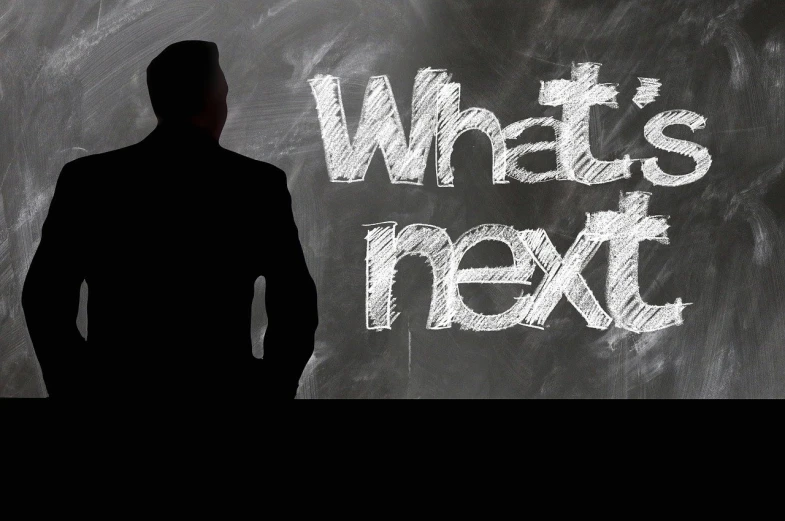 a man standing in front of a chalkboard with what's next written on it, a picture, trending on pixabay, happening, silhouette of a man, in the near future, b, what