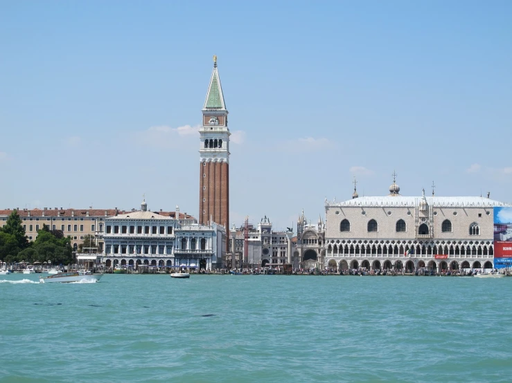 a large body of water with a clock tower in the background, inspired by Quirizio di Giovanni da Murano, shutterstock, venice biennale, shot from afar, summer 2016, masking