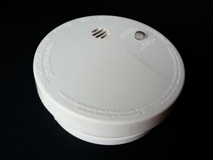 a close up of a smoke detector on a table, pixabay, bauhaus, battery, white plastic, 4 0 0 mm, prototype