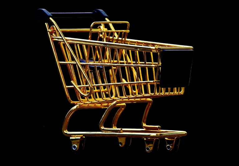 a golden shopping cart on a black background, flickr, modernism, oversaturated, tourist photo, side-view, retaildesignblog.net