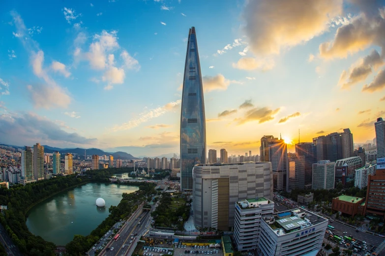 a very tall building in the middle of a city, a picture, by Simon Gaon, shutterstock, gwanghwamun, stunning scenery, vibrant light, peak experience ”