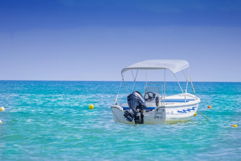 a motor boat in the middle of the ocean, a photo, by Edward Corbett, shutterstock, mediterranean beach background, dingy, stock photo