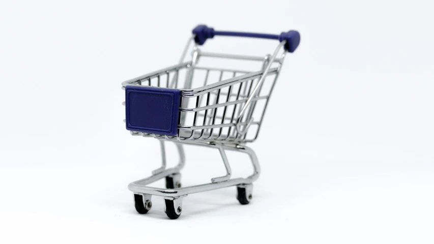 a miniature shopping cart on a white surface, slight overcast lighting, blueish, retaildesignblog.net, kantoku