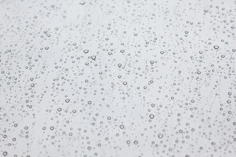 a close up of water droplets on a window, inspired by Vija Celmins, minimalism, clean white lab background, it\'s raining, high res photo