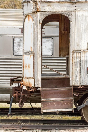 an old train car sitting on the tracks, a portrait, by Richard Carline, unsplash, assemblage, australian, very sparse detail, high body detail, white steel