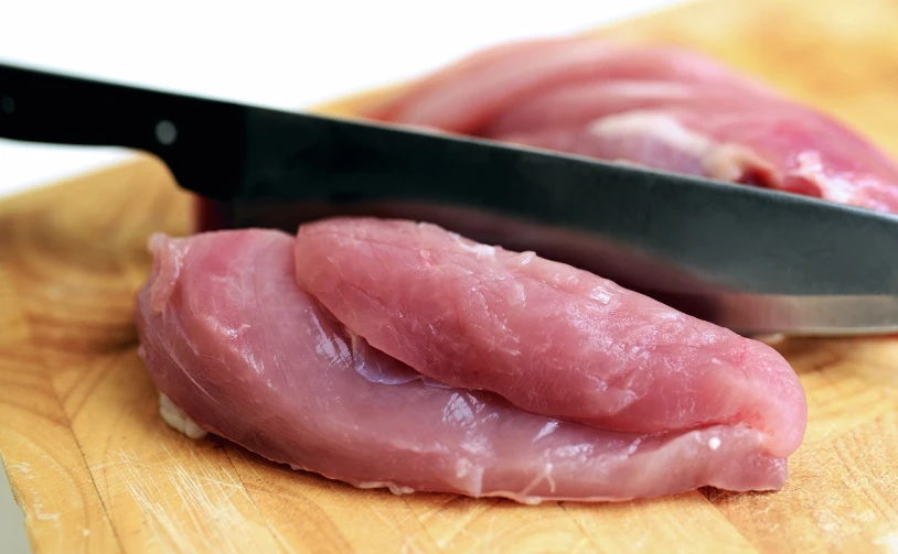 a close up of meat on a cutting board with a knife, a picture, chicken, istockphoto, half body photo, image