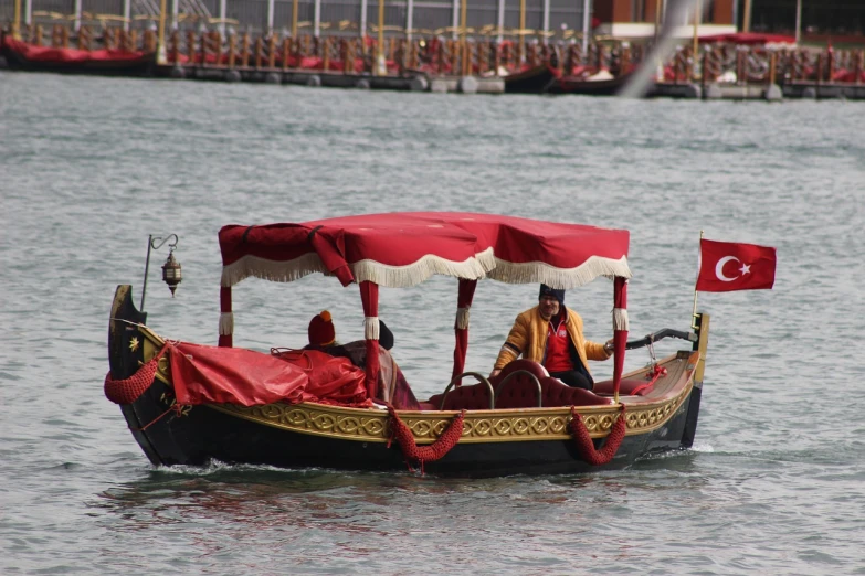 a group of people riding on top of a boat, inspired by Antonio Ciseri, flickr, hurufiyya, venetian red, 1 female, no crop, carriage