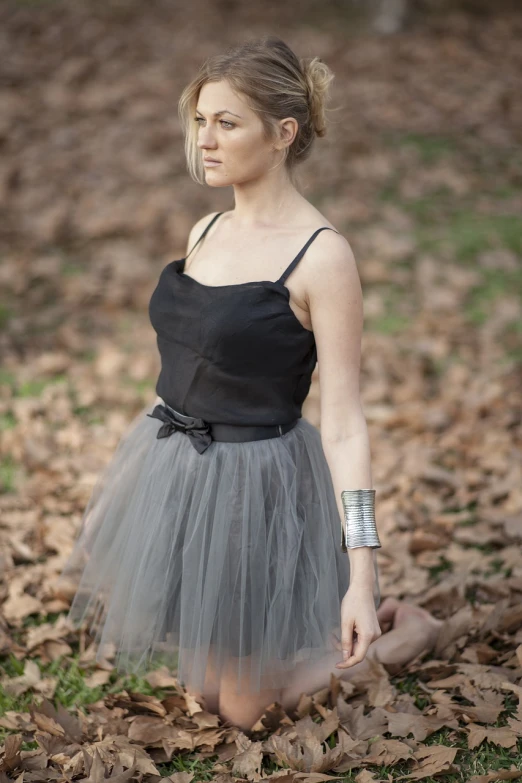 a woman in a tutu posing for a picture, a portrait, inspired by Emma Andijewska, tumblr, purism, wearing two silver bracelets!, environmental portrait, 3 / 4 view portrait, straps