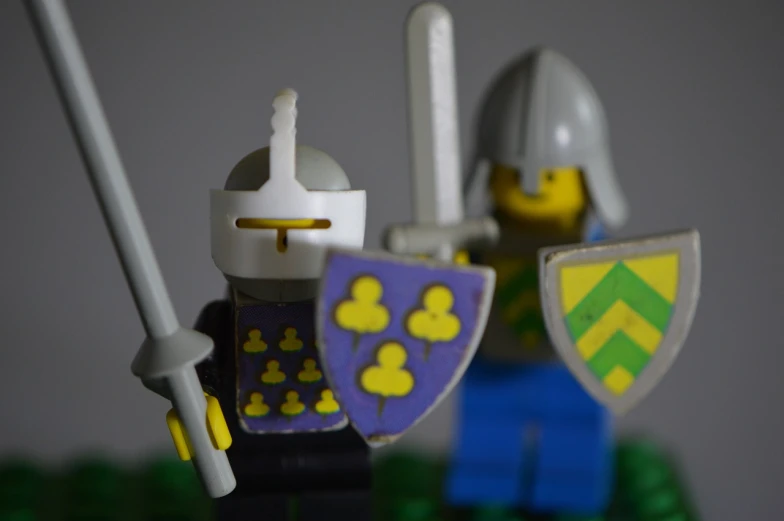 a couple of lego knights standing next to each other, a picture, inspired by Simon de Vlieger, flickr, arms of lemons, heraldry, highlight, teaser