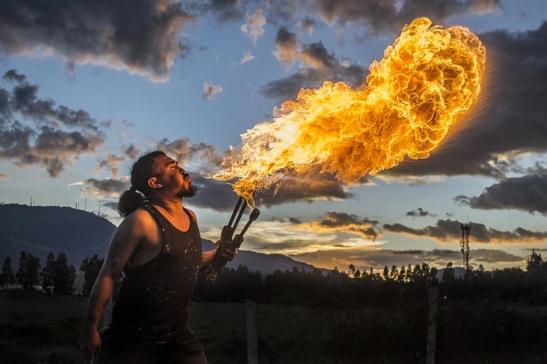 a man that is standing in the grass with a fire, a portrait, by Sebastian Spreng, fire breathing. bowser, epic clouds and lighting, chile, very very very realistic