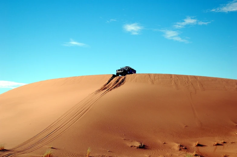 a jeep driving down a sand dune in the desert, a photo, hurufiyya, wallpaper!, australia intricate, de tomaso, beautiful place