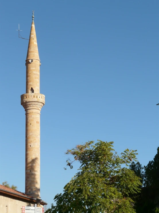 a tall tower with a clock on top of it, inspired by Fikret Muallâ Saygı, hurufiyya, blonde, lead - covered spire, turkey, ivy