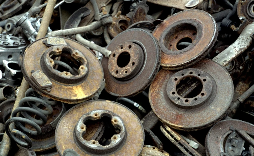 a pile of rusty metal parts sitting on top of each other, deep dish wheels, circular, high quality product image”, photograph credit: ap