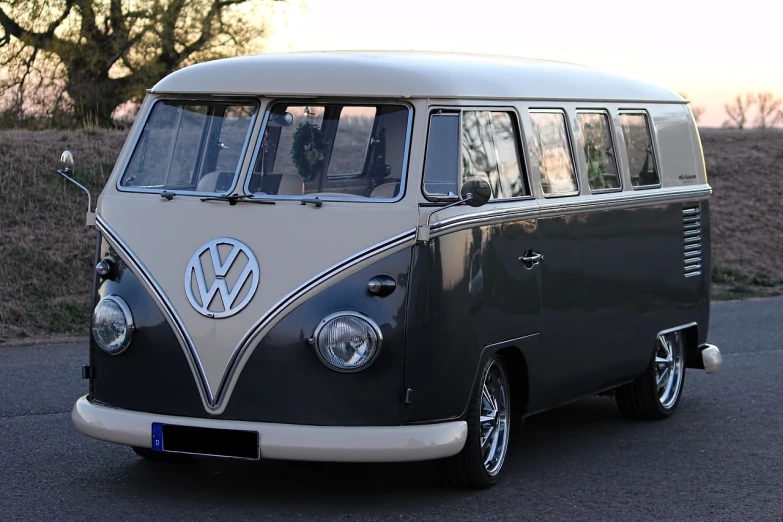 a black and white vw bus driving down a street, trending on pixabay, retrofuturism, grey metal body, wide windows, extremely polished, it has six thrusters in the back