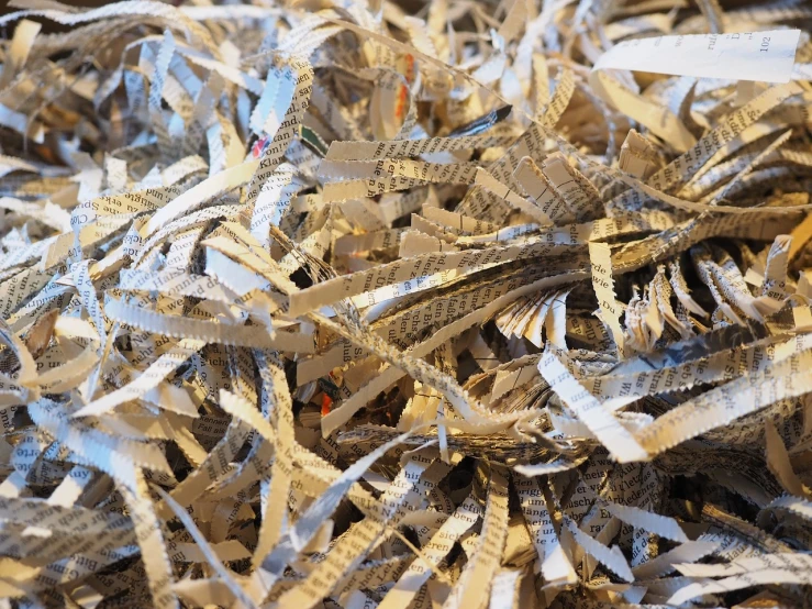 a pile of shredded paper sitting on top of a table, plasticien, full of silver layers, very sharp photo