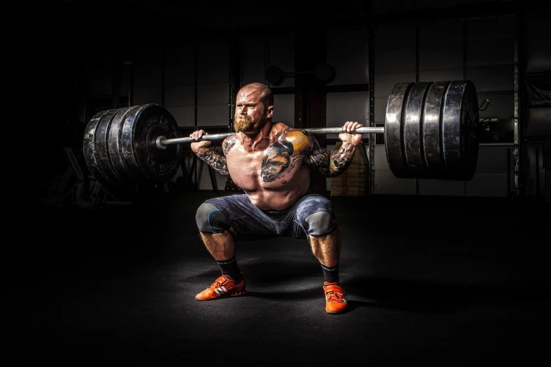 a man doing a squat with a barbell, a portrait, by Hristofor Žefarović, pexels contest winner, figuration libre, muscular body tattooed, greg rutkowski uhd 8k, thrusters, strong colours
