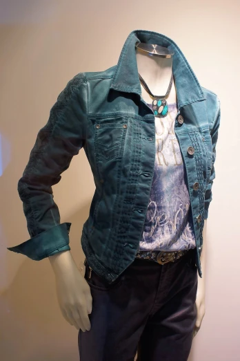 a mannequin dressed in a blue jacket and tie, inspired by Bob Singer, pop art, leather jacket and denim vest, teal tones, female outfit, visible stitching