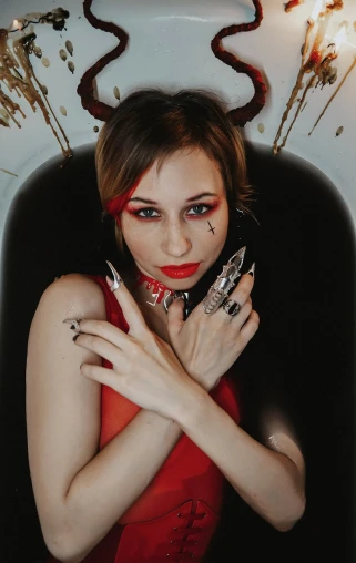 a woman in a red dress holding a cell phone, an album cover, inspired by Hedi Xandt, tumblr, gothic art, bleeding in the bath, photo of a hand jewellery model, cutecore clowncore, bat claws