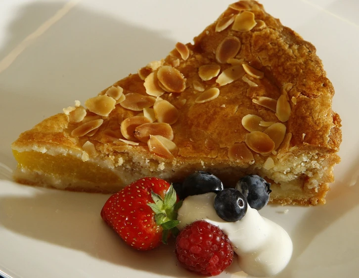 a piece of pie sitting on top of a white plate, inspired by Richmond Barthé, renaissance, bogna gawrońska, patriotic, half moon, fruit