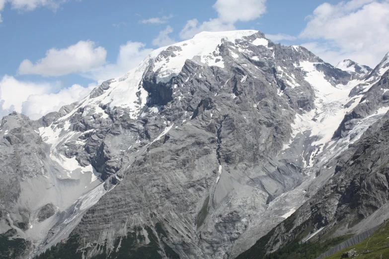 a herd of cattle standing on top of a lush green hillside, a picture, by Werner Andermatt, hurufiyya, with a snowy mountain and ice, carrara marble, an ice volcano, very sharp photo