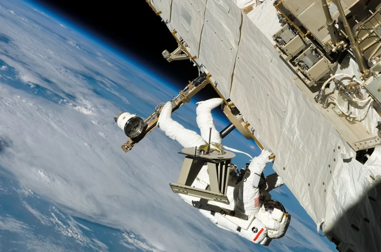 a view of the earth from a space station, a photo, space walk scene, 2 0 1 0 photo, spaceship being repaired, profile shot