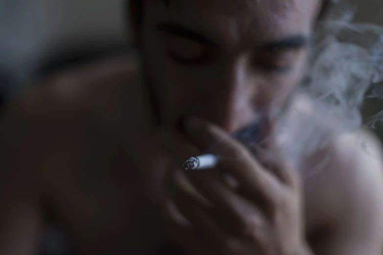 a shirtless man smokes a cigarette, a portrait, by Elsa Bleda, shutterstock, blurry image, around 20 yo, stock photo, smoke under the ceiling