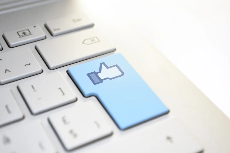 a close up of a computer keyboard with a thumbs up button, by Julian Allen, shutterstock, digital art, facebook profile picture, digital asset, full body image, blue