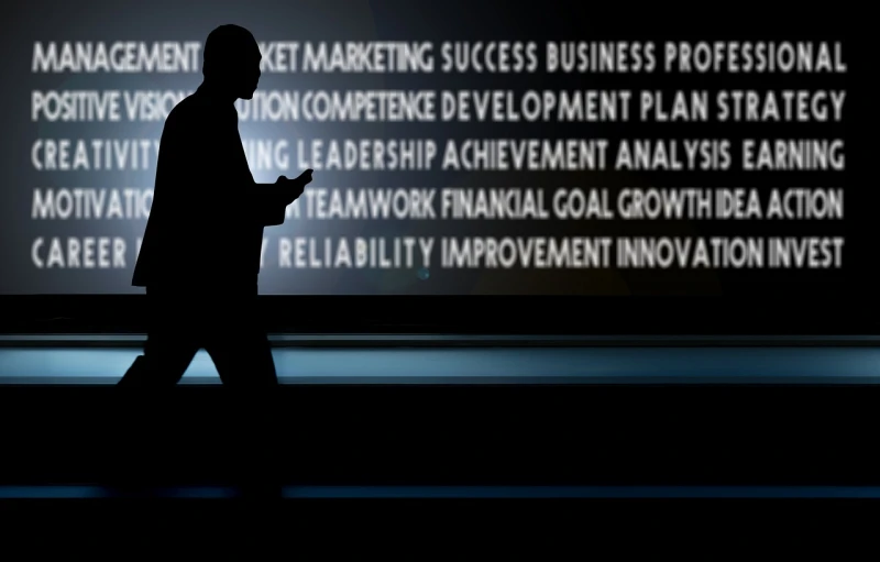 a silhouette of a man standing in front of a screen, digital art, digital art, executive industry banner, phone photo, words, success