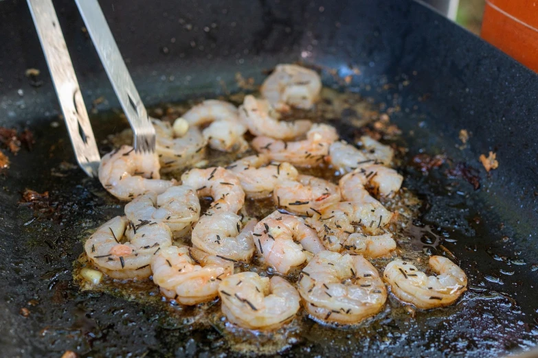 shrimp being cooked in a frying pan with tongs, by Paul Emmert, process art, al fresco, caparisons, boston, symphony