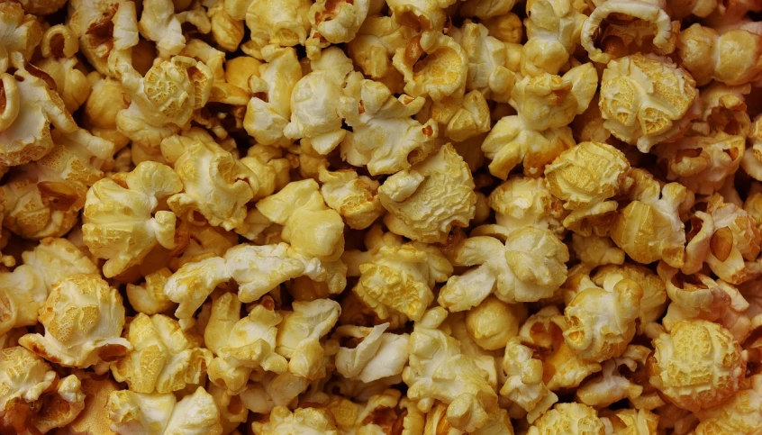 a pile of popcorn sitting on top of a table, a portrait, renaissance, high detail product photo, yellow-orange, detailed zoom photo, olive