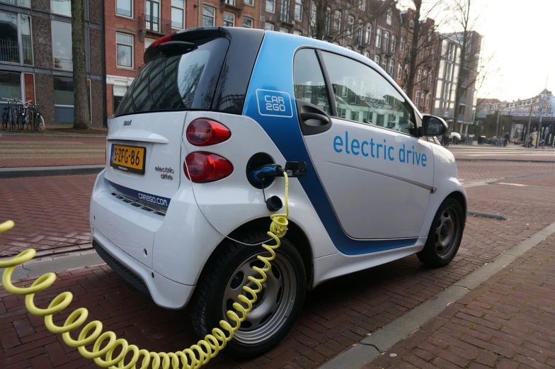 a smart car plugged into an electric charger, by Paul Emmert, pixabay, les automatistes, amsterdam, highly detailed!, codachrome, car on highway