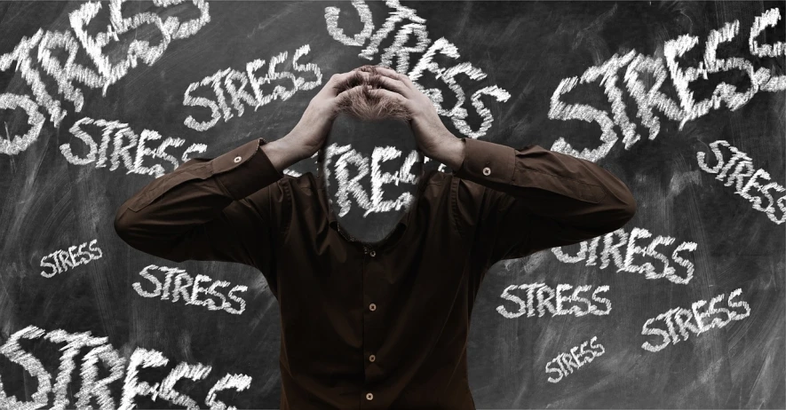 a man standing in front of a chalkboard with words written on it, by Arthur Sarkissian, shutterstock, surrealism, stress, head in hands, detailed image, stressed