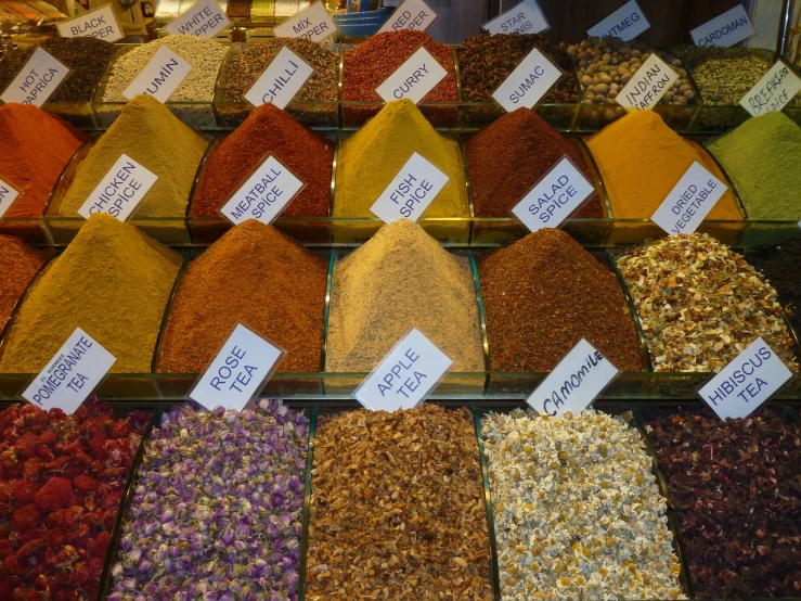 a display case filled with lots of different types of spices, a photo, by Edward Ben Avram, pexels, renaissance, mixture turkish and russian, squares, honey, is a stunning