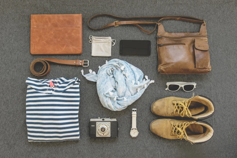 the contents of a bag are laid out on the floor, a picture, minimalism, vintage pilot clothing, beautiful high resolution, wearing casual clothes, photography”