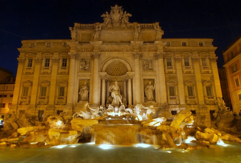 a large fountain with statues lit up at night, pexels contest winner, neoclassicism, piranesi style, draped with water and spines, young handsome pale roma, cascade