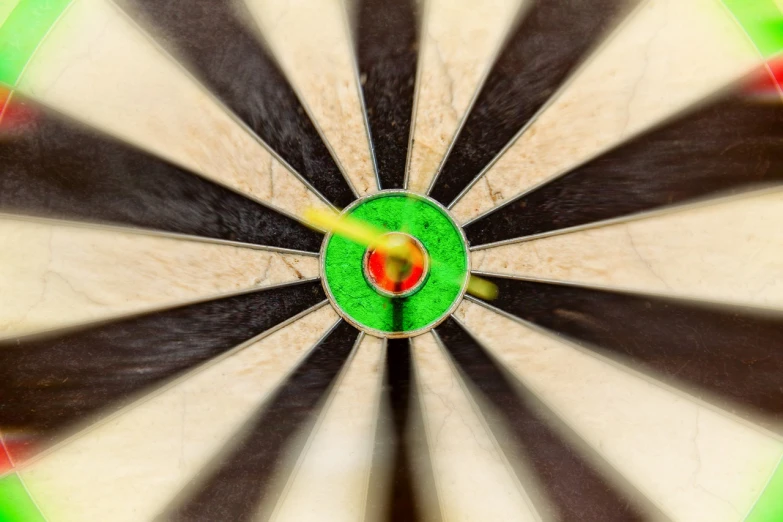 a close up of a dart in a bullseye, by Dietmar Damerau, precisionism, istockphoto, longbows, 70s photo, a green