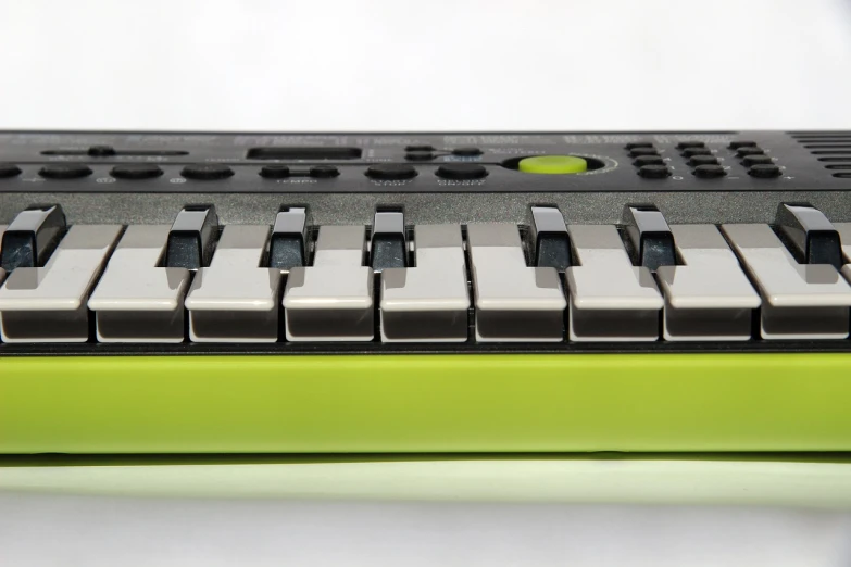 a close up of a keyboard on a table, a picture, inspired by Pál Böhm, lime green, miniature product photo, profile, cassette