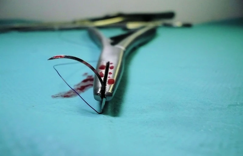 a pair of scissors sitting on top of a table, by Eugeniusz Zak, flickr, hurufiyya, operating room, teeth bared, wire management, gory