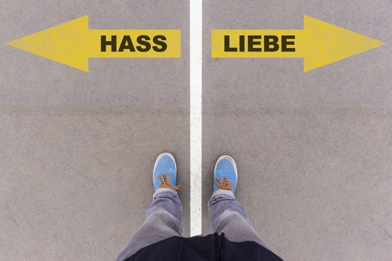 a person standing in front of two yellow arrows, by Thomas Häfner, viennese actionism, love hate love, hsv, with massive, auslese