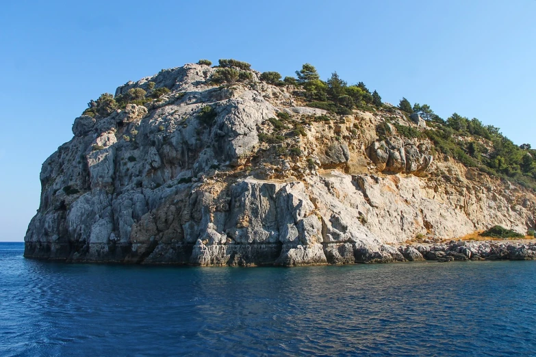 a large rock in the middle of a body of water, by January Suchodolski, flickr, les nabis, greek fantasy panorama, photo taken from a boat, rocky hills, vacation photo