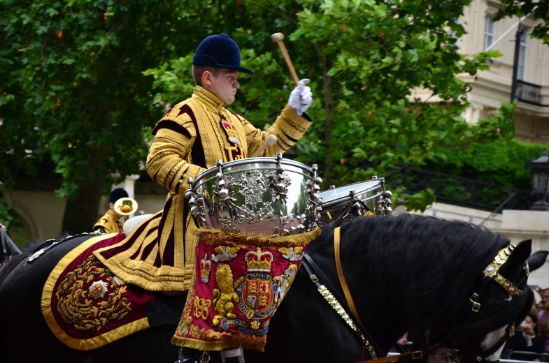 a man riding on the back of a black horse, by Robert Brackman, shutterstock, baroque, drum kit, queen elizabeth ii, very sharp and detailed photo, stock photo