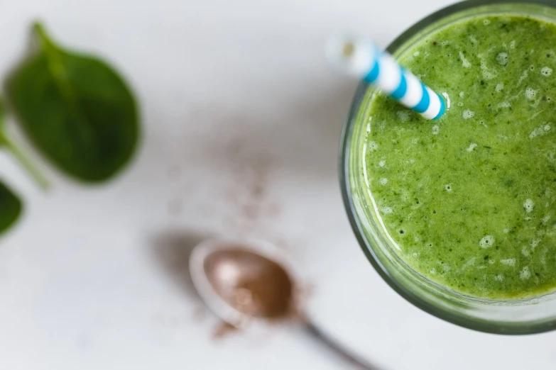 a green smoothie with a blue and white striped straw, a portrait, by Jakob Gauermann, unsplash, green and brown tones, shiny!!, powder, lotus