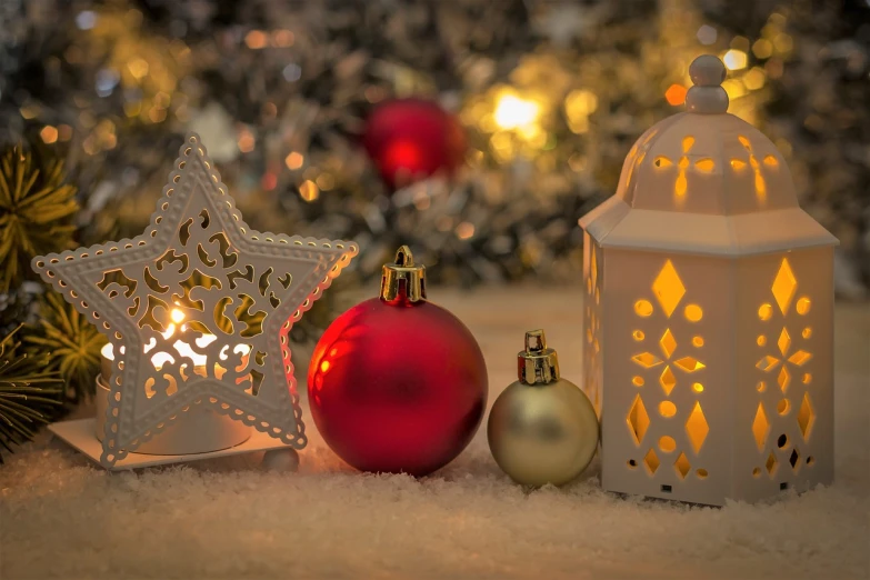 a white lantern sitting on top of a snow covered ground, a picture, pixabay, digital art, candles in foreground, red white and gold color scheme, star, glittering silver ornaments